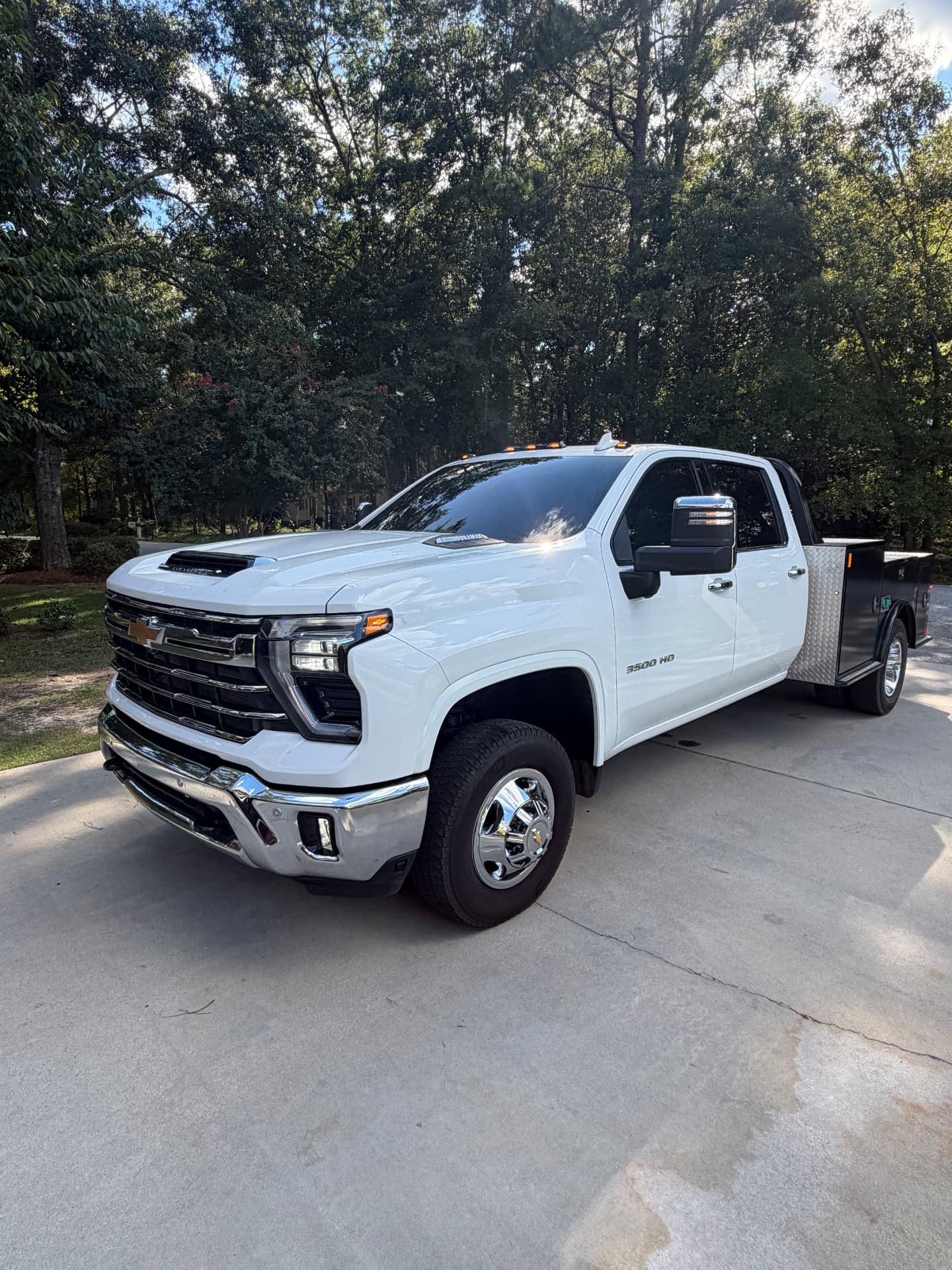 White Chevrolet heavy-duty utility truck showing its tinted cab windows