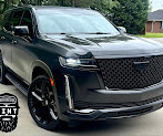 Black SUV with tinted windows parked outside