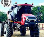 Front view of a red tractor with an enclosed tinted cab