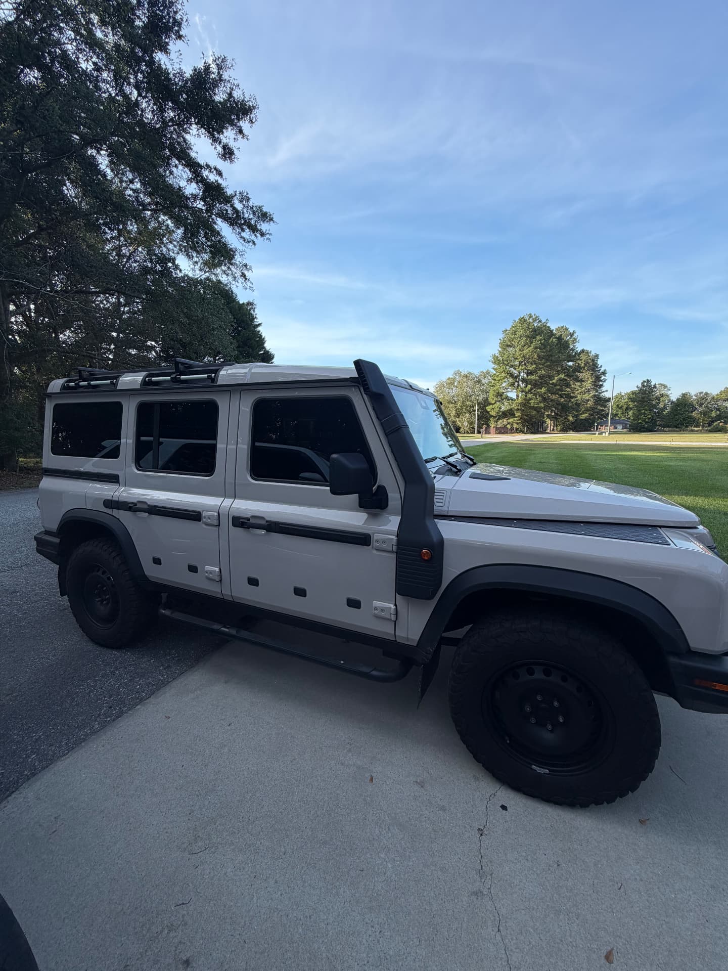 Light-colored off-road SUV with tinted side windows
