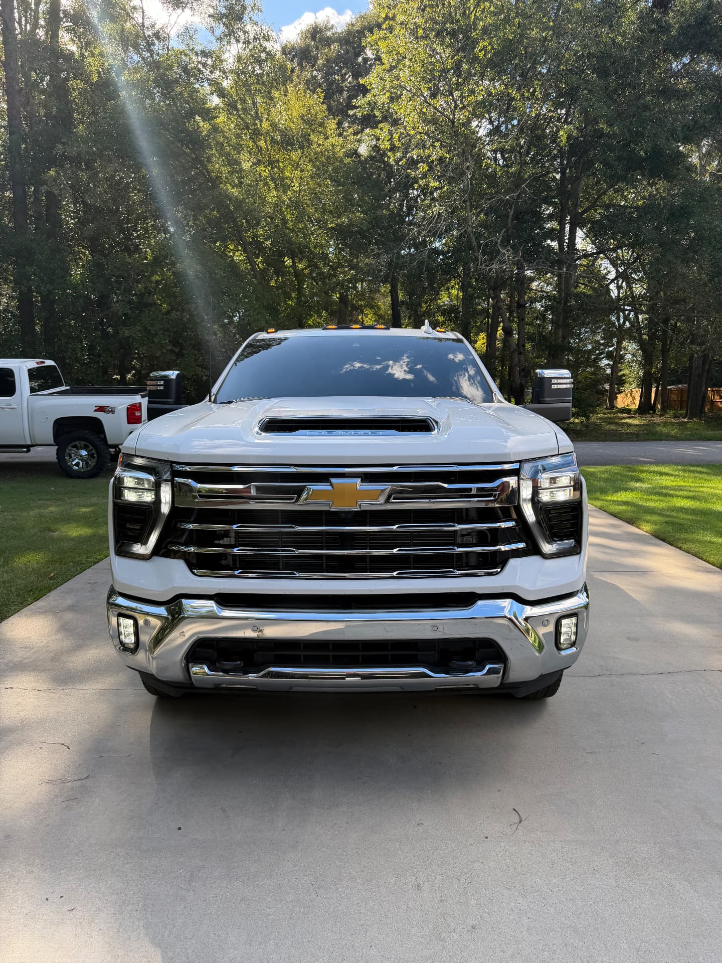 Front view of a white Chevrolet heavy-duty truck showing its windshield