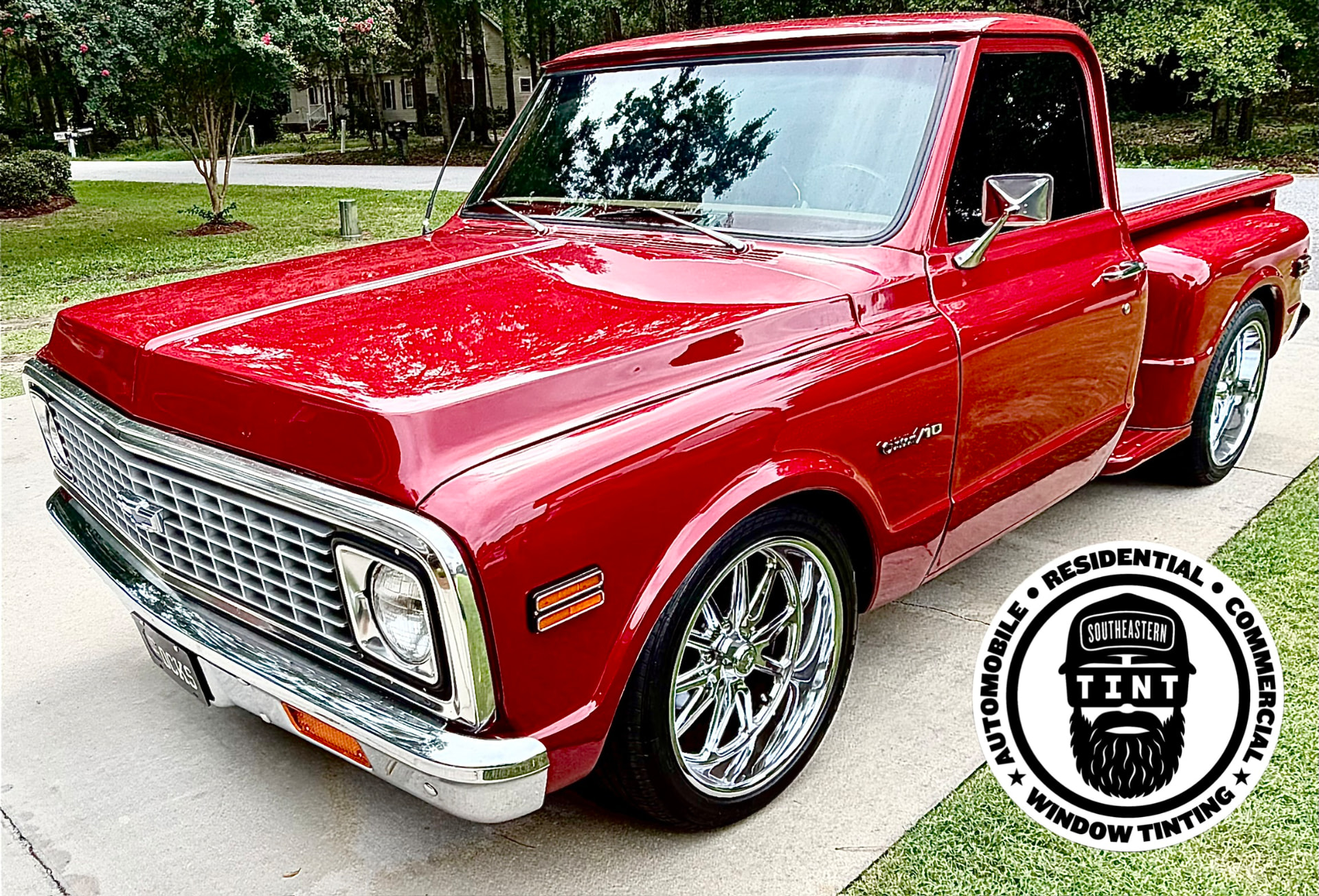 Classic red Chevrolet pickup with tinted side window and Southeastern Tint logo