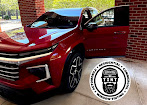 Red sedan at the workshop with the driver door open