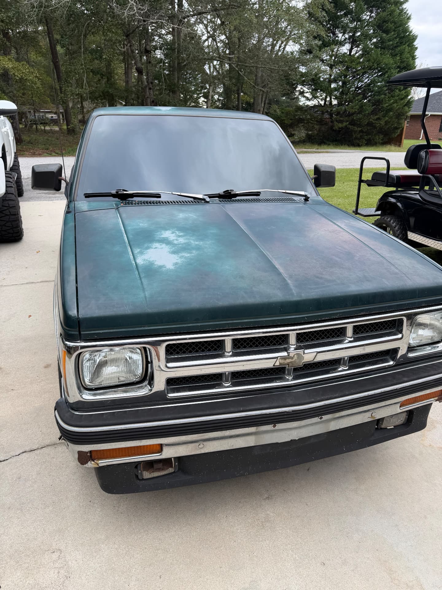 Front view of a green Chevrolet pickup showing its windshield