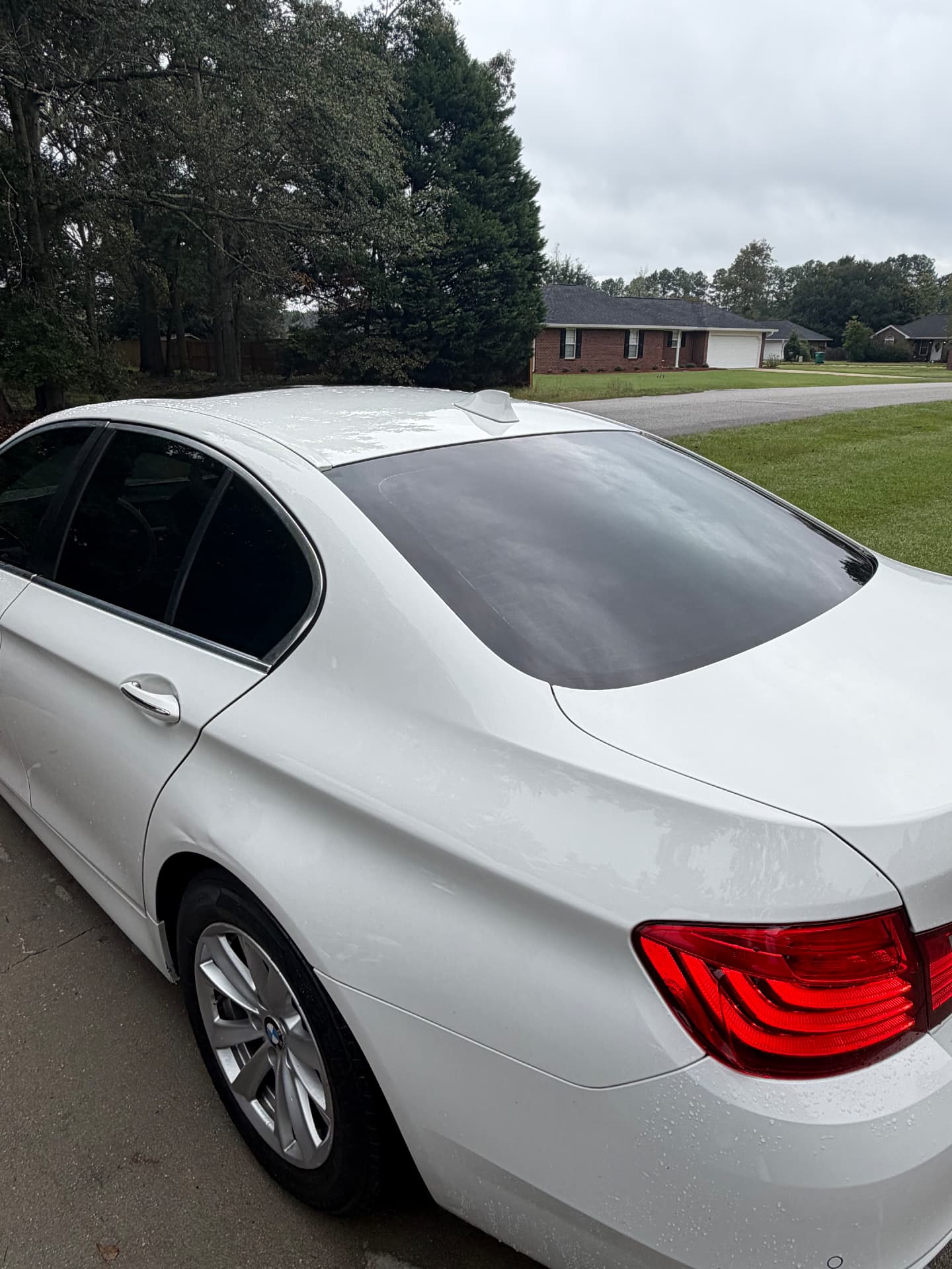 White BMW sedan showing tinted rear and side windows